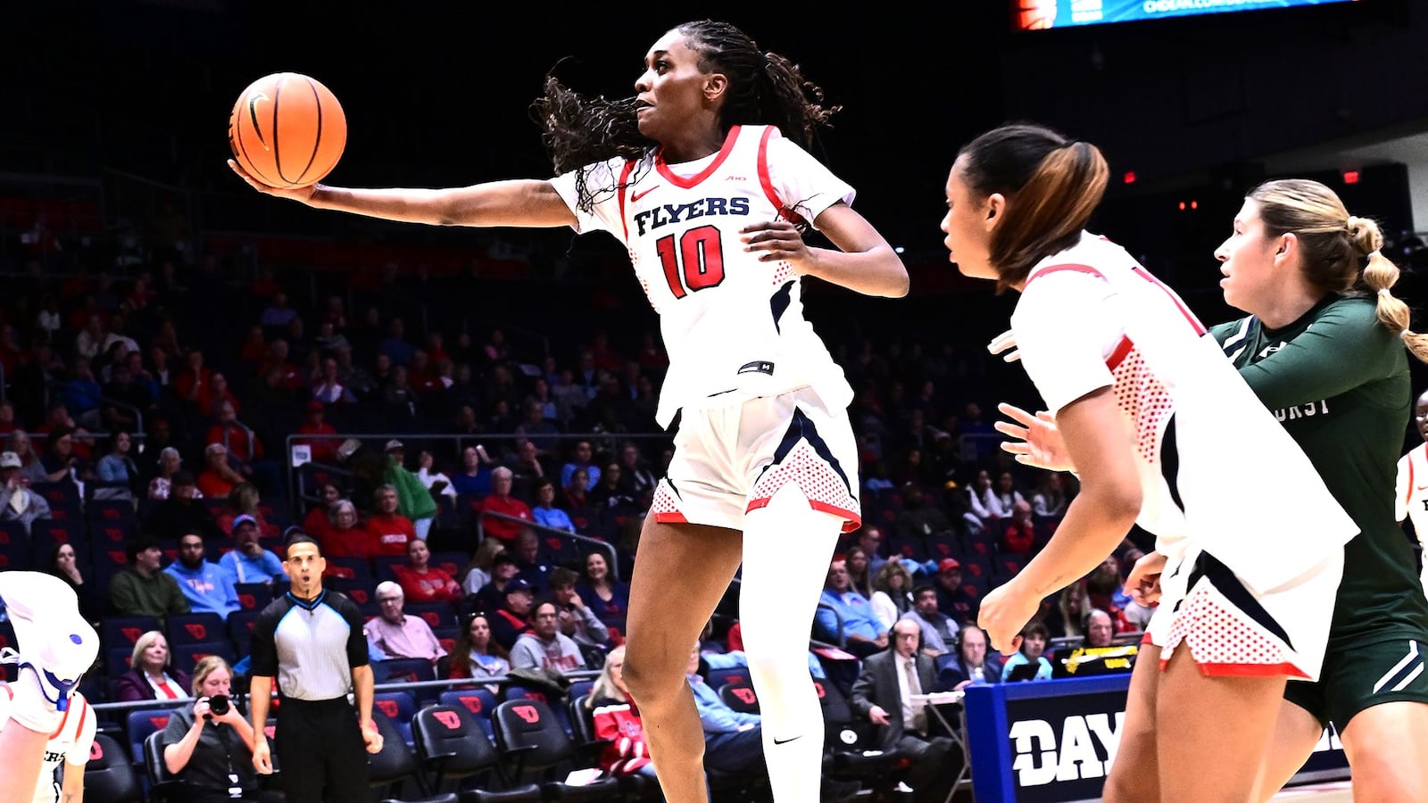 Fatima Ibrahim stretches to corral the basketball in a Dayton Flyers game against Mercyhurst earlier this month. The 6-foot-3 junior transfer from North Dakota leads the Flyers in field goal percentage (80.8 percent), rebounds (8.8 rpg) and blocked shots (2.3 bpg) and is second in scoring (13.3 ppg). CONTRIBUTED PHOTO