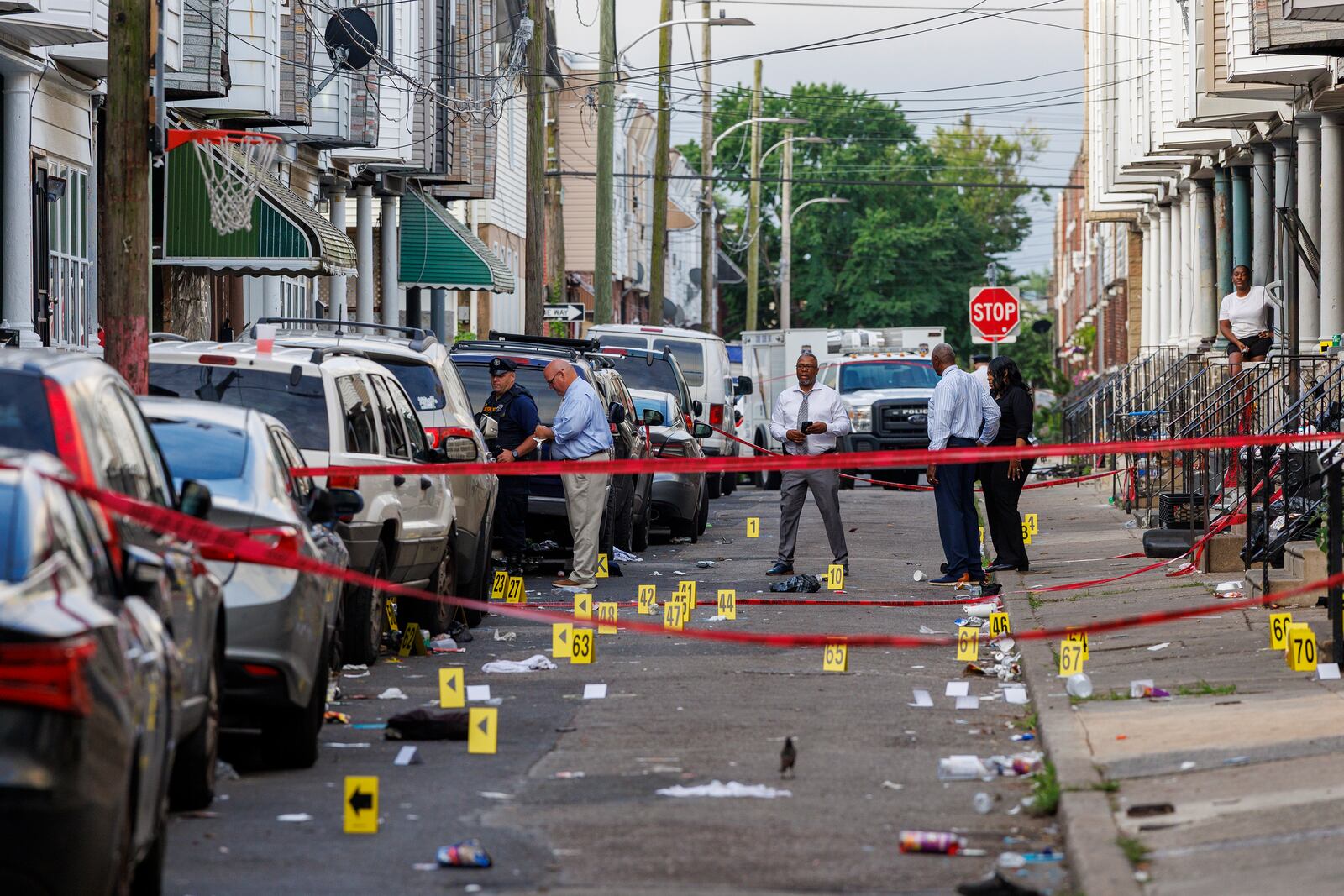Crime scene evidence markers line a street in Philadelphia after an overnight shooting, early Monday, July 7, 2025. (Alejandro A. Alvarez/The Philadelphia Inquirer via AP)