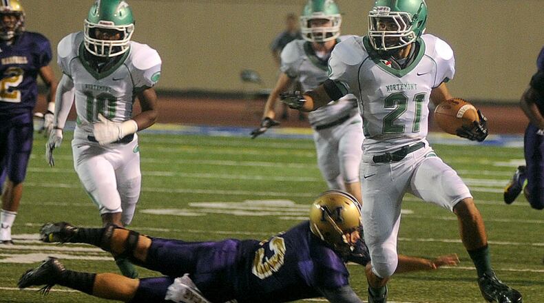 Northmonts D.J. Hickman, 21, breaks away from a Thurgood Marshall’s tackle during Friady night action at Welcome Stadium. MARSHALL GORBY / STAFF