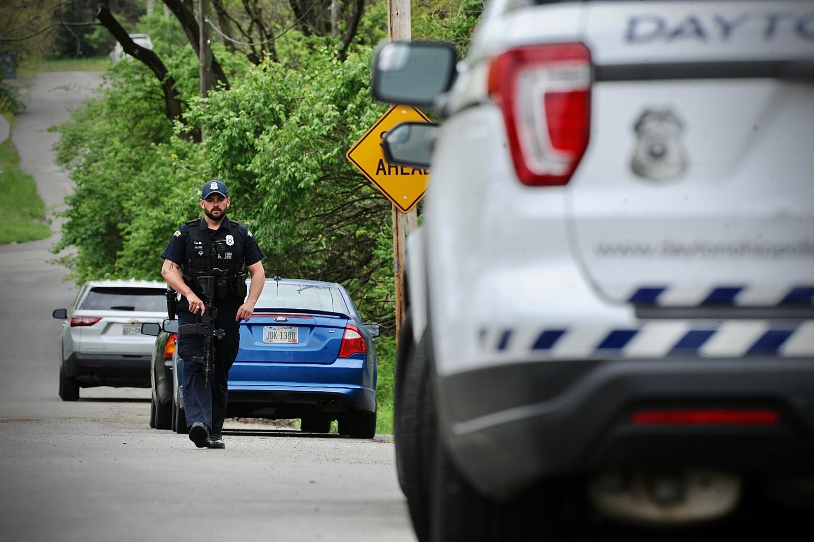 Dayton police looked for an armed suspect in a wooded area near Gettysburg and McCall Avenue. The suspect rammed a police cruiser and ran.