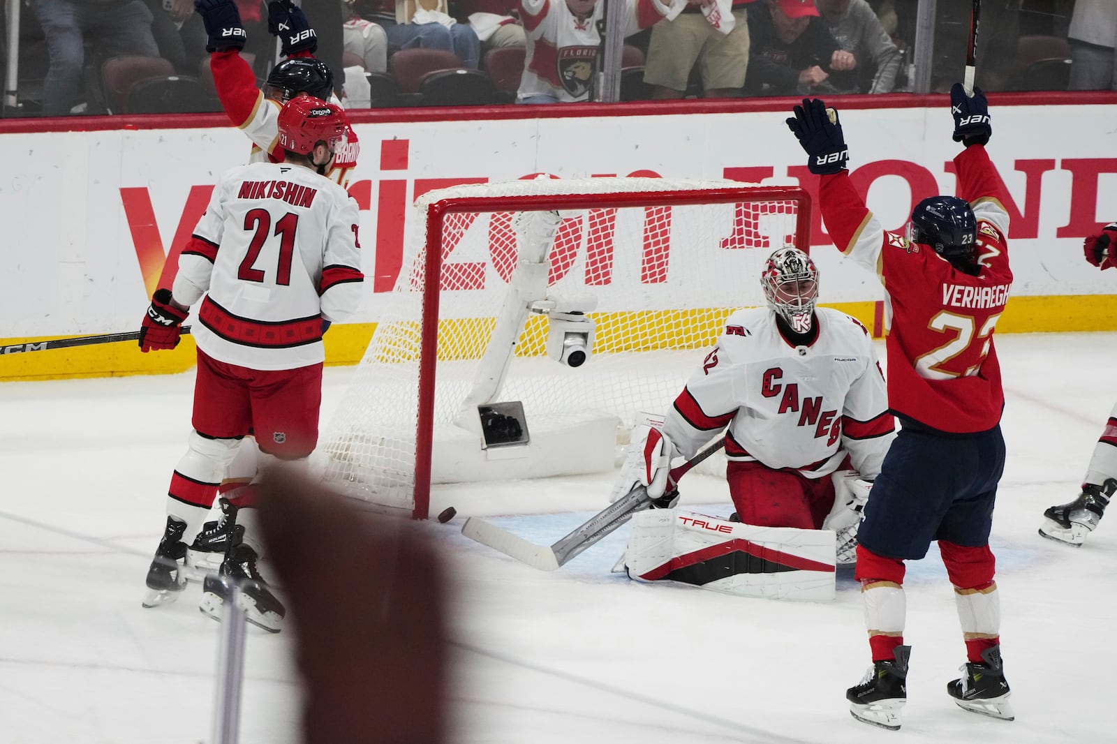 The puck gets past Carolina Hurricanes goaltender Pyotr Kochetkov, center, on a goal scored by Florida Panthers' Aleksander Barkov during the third period in Game 3 of the NHL hockey Stanley Cup Eastern Conference finals Saturday, May 24, 2025, in Sunrise, Fla. (AP Photo/Lynne Sladky)