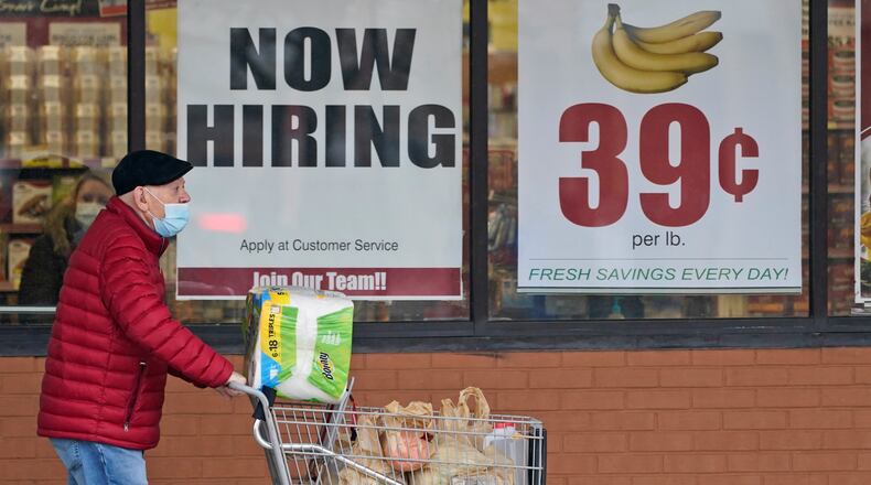 FILE - A man walks out of a Marc's Store, Friday, Jan. 8, 2021, in Mayfield Heights, Ohio. Fewer Americans applied for unemployment benefits last week, lowering claims to 900,000, still a historically high level that points to further job cuts in a raging pandemic. (AP Photo/Tony Dejak, file)