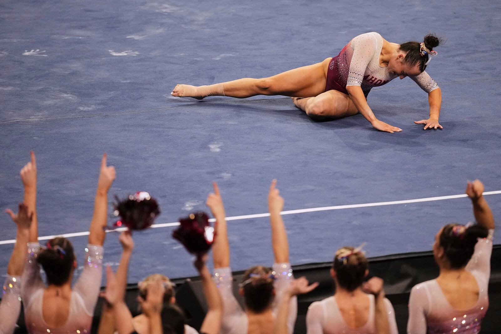 Oklahoma's Faith Torrez competes on the floor exercise as the team cheers her on during the NCAA women's gymnastics championships in Fort Worth, Texas, Thursday, April 17, 2025. (AP Photo/Tony Gutierrez)