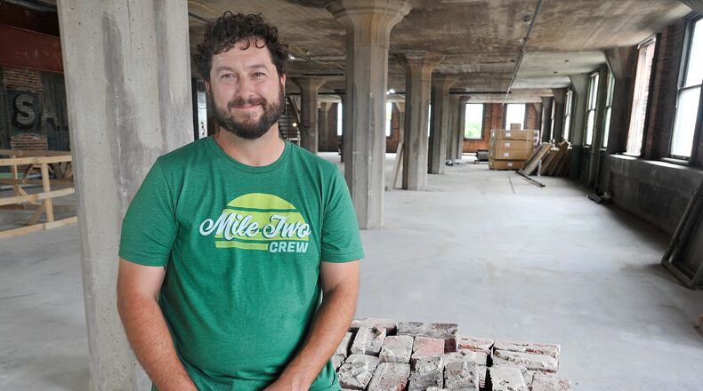 Jeff Graley, founder and CEO, of the Dayton software firm Mile Two, poses for a photo in his companies new location at the Manhattan on Third Street. MARSHALL GORBY\STAFF