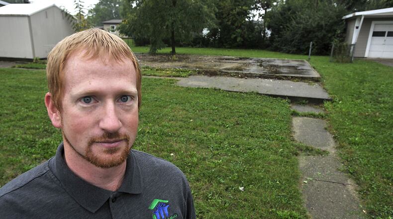 Matt Wilson, executive director of Clark County Habitat for Humanity, at a vacant lot in New Carlisle that the group plans to build a new house on. Bill Lackey/Staff