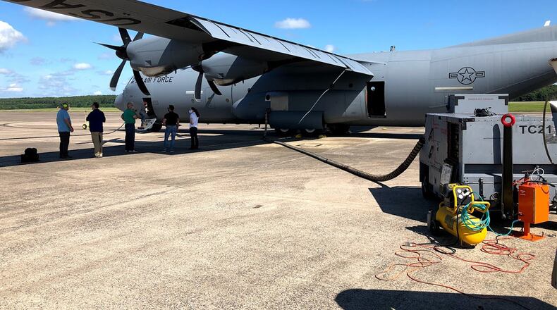 A C-130 is prepped for simulant dissemination, after which the aircraft will be taxied and then flown to measure the rate at which the simulant leaves the aircraft. CONTRIBUTED PHOTO