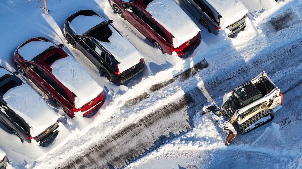 Crews clean up the lot at Matt Castrucci Auto Mall near the Dayton Mall on Monday, Jan. 26, 2026. NICK GRAHAM / STAFF