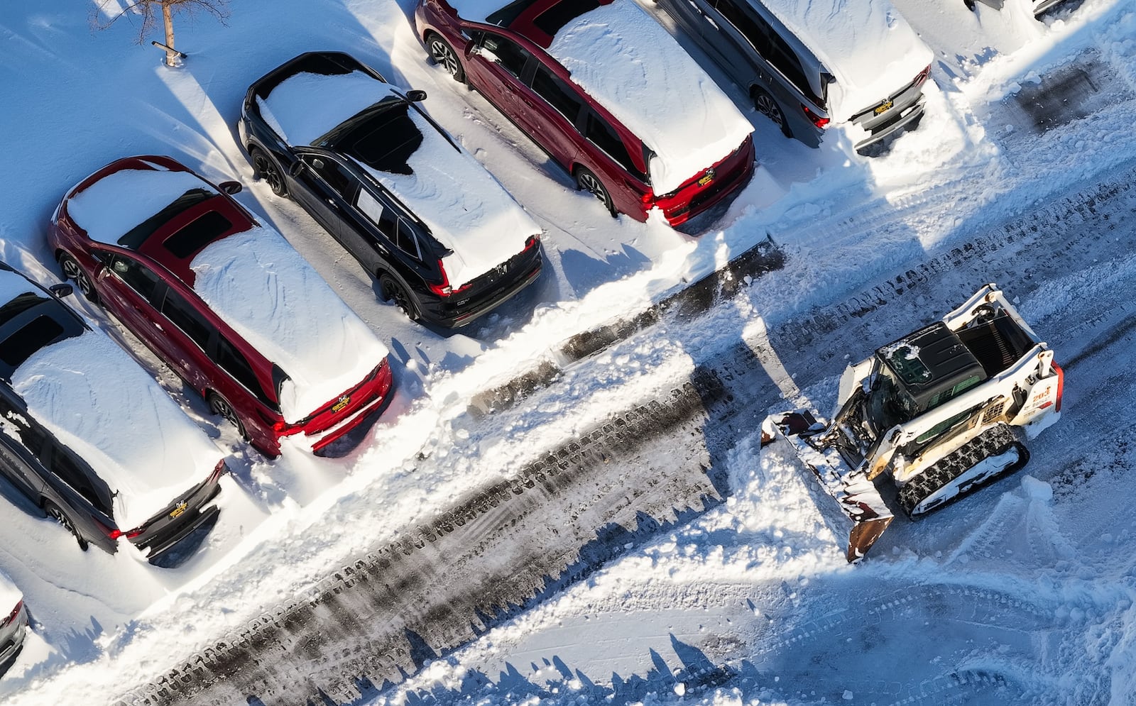 Crews clean up the lot at Matt Castrucci Auto Mall near the Dayton Mall on Monday, Jan. 26, 2026. NICK GRAHAM / STAFF