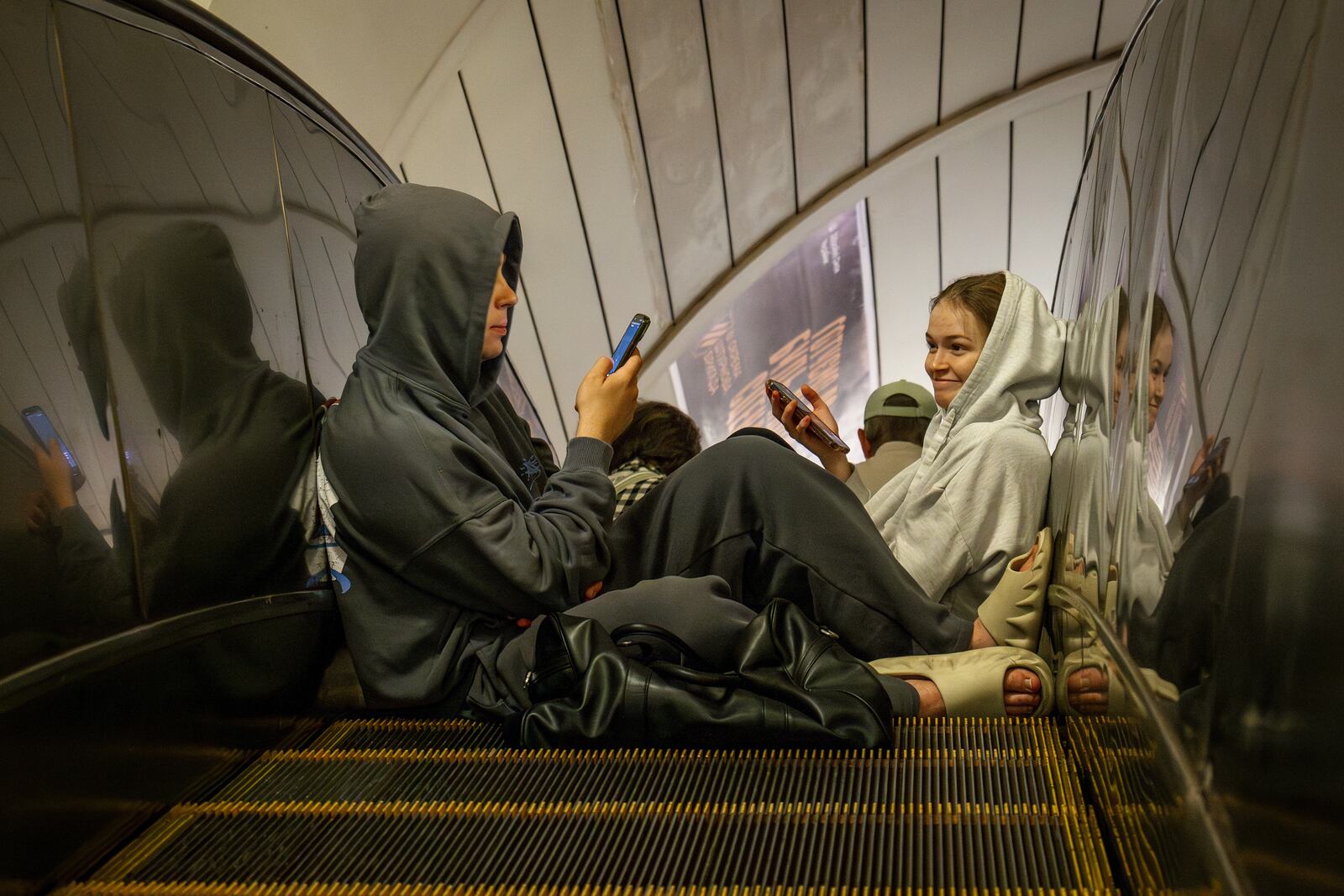 People rest in a metro station, being used as a bomb shelter, during a Russian drones attack in Kyiv, Ukraine, early Tuesday, June 10, 2025. (AP Photo/Dan Bashakov)