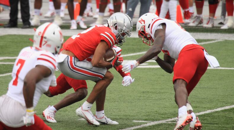 Ohio State's Chris Olave prepares to take a hit against Nebraska on Saturday, Oct. 24, 2020, at Ohio Stadium in Columbus. David Jablonski/Staff