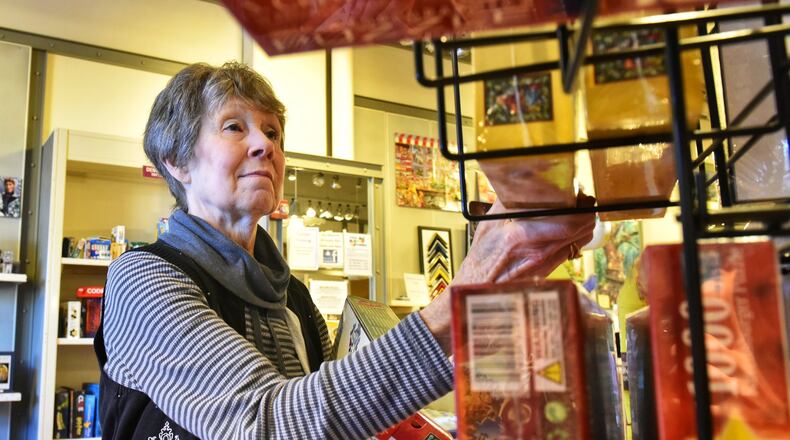 Pat Kothman shops for gifts at Puzzles Plus at The Greene Town Center in Beavercreek Thursday, Dec. 19. NICK GRAHAM/STAFF