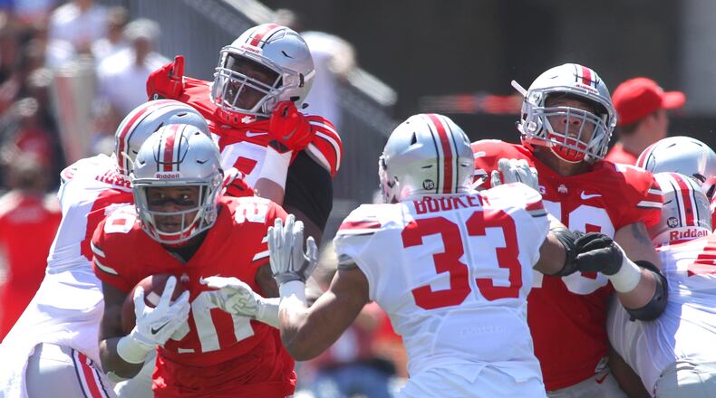 Mike Weber (20) and Dante Booker (33) are a pair of Ohio State players who could join the starting lineup for the first time this fall. David Jablonski/Staff