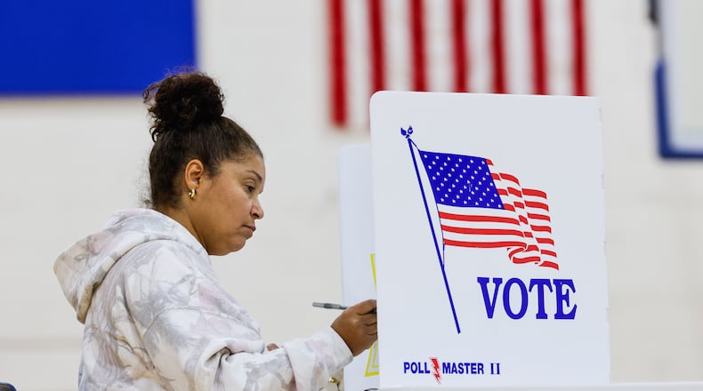 Rachelle Sims fills out a provisional ballots at the polling location in the gymnasium of Garfield Middle School Tuesday, Nov. 4, 2025 in Hamilton. NICK GRAHAM/STAFF