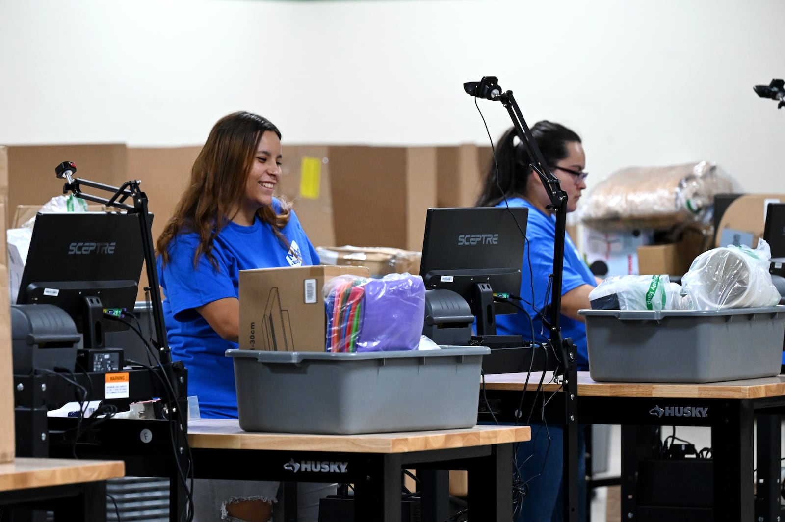 MAC.BID, an online auction retailer, and its Yinz Binz retail store, is open for business at 1204 Main St., on Hamilton's west side. They are open from noon to 6 p.m. seven days a week. Pictured are employees scanning auction items to be placed on shelves on Thursday, Aug. 21, 2025. MICHAEL D. PITMAN/STAFF
