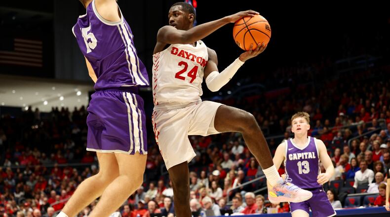Dayton's Kobe Elvis looks to make a pass against Capital in an exhibition game on Saturday, Oct. 29, 2022, at UD Arena. David Jablonski/Staff