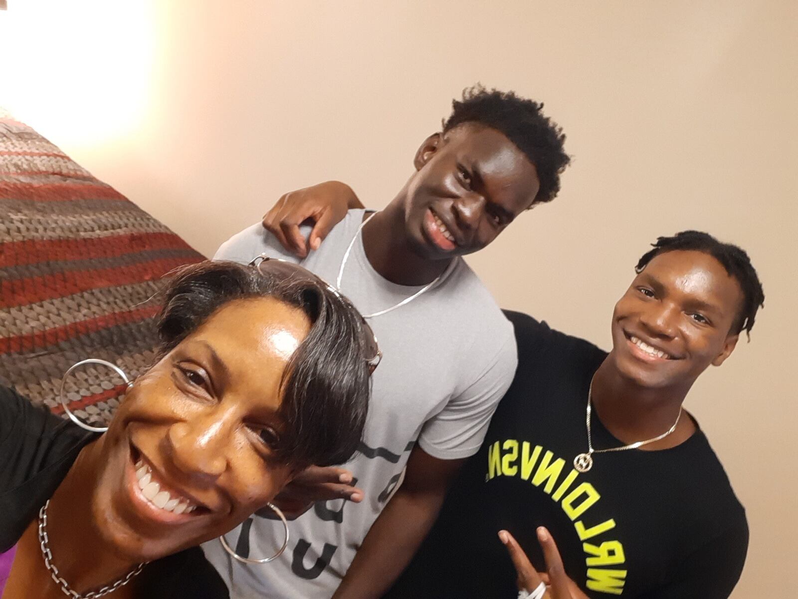Ibrahima Jarjou (center) with Penny Williams, the Atlanta-area based realtor and college basketball and track standout, who became his host mom here in the United States and Williams son, Felix Uadiale (right) who was a rival high school player of Jarjou’s in Georgia  and now has become his good friend…. Uadiale plays at Shawnee State in Portsmouth. (Contributed Photo)