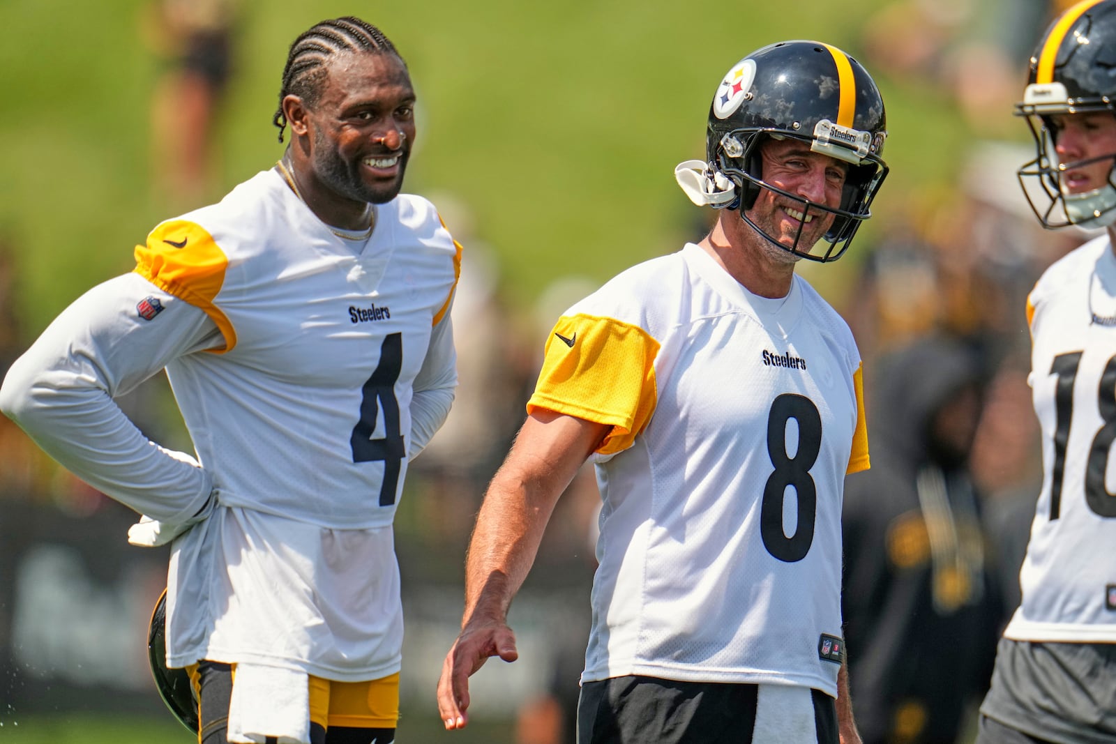 Pittsburgh Steelers quarterback Aaron Rodgers (8) and wide receiver D.K. Metcalf (4) smile during practice at the NFL football team's training camp in Latrobe, Pa., Wednesday, July 23, 2025. (AP Photo/Gene J. Puskar)