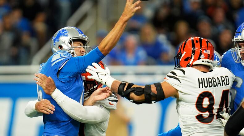 Detroit Lions quarterback Jared Goff is pressured by Cincinnati Bengals defensive end Trey Hendrickson during the first half of an NFL football game, Sunday, Oct. 17, 2021, in Detroit. (AP Photo/Paul Sancya)