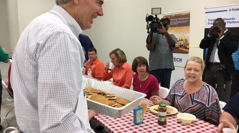 Sen. Rob Portman served pancakes to employees of Trimble in Huber Heights Monday morning. Afterwards, he visited with patients and counselors at a Dayton rehabilitation center. THOMAS GNAU/STAFF