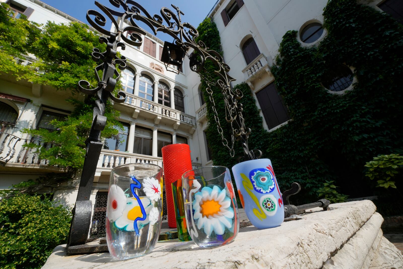 Art glasses are displayed at the Laguna B glassmaker headquarter courtyard, in Venice, Italy, Thursday, June 12, 2025. (AP Photo/Luca Bruno)