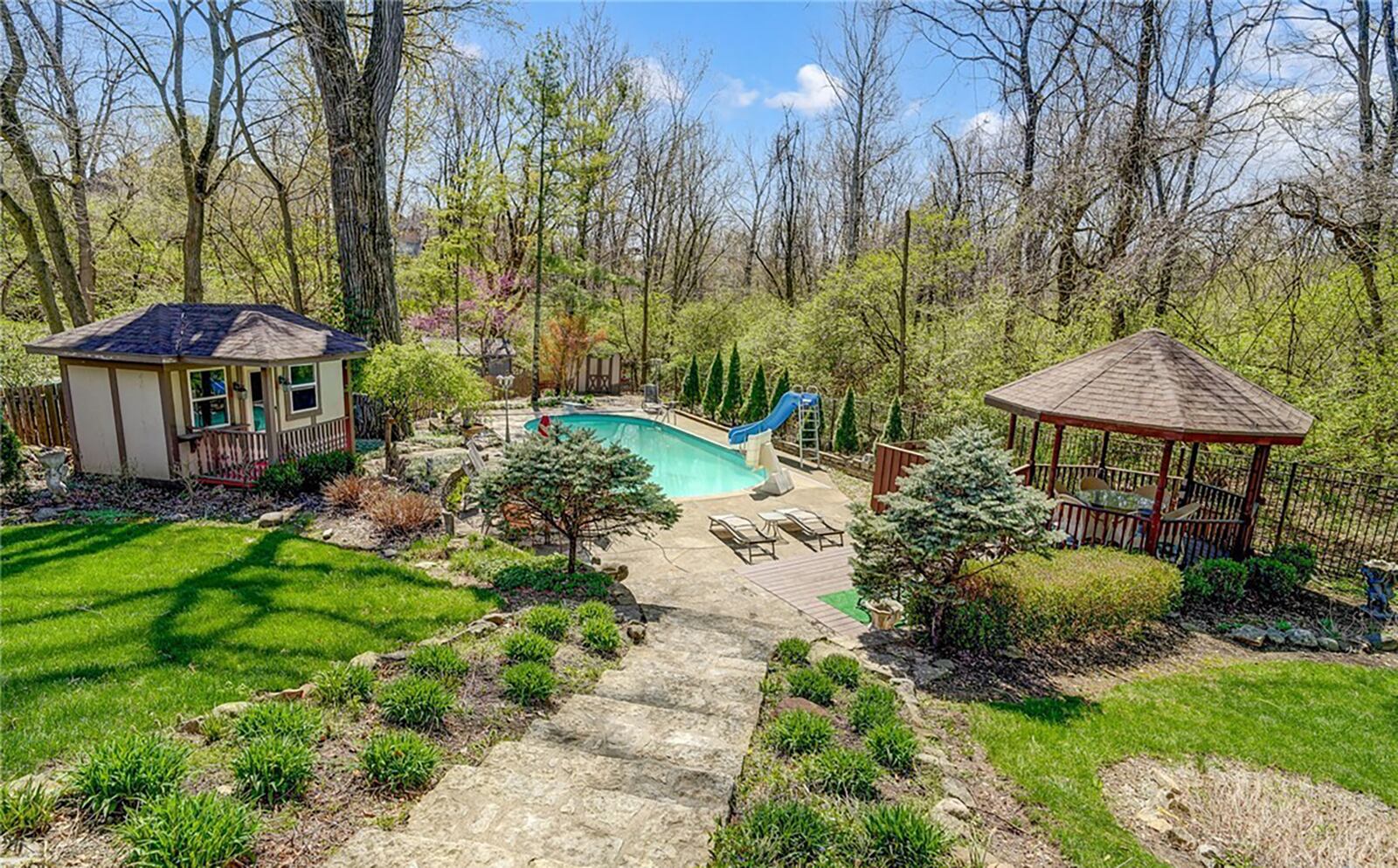 The home has a pool with an automatic cover, diving board and slide. There is also a gazebo with ceiling fan and a pool house.