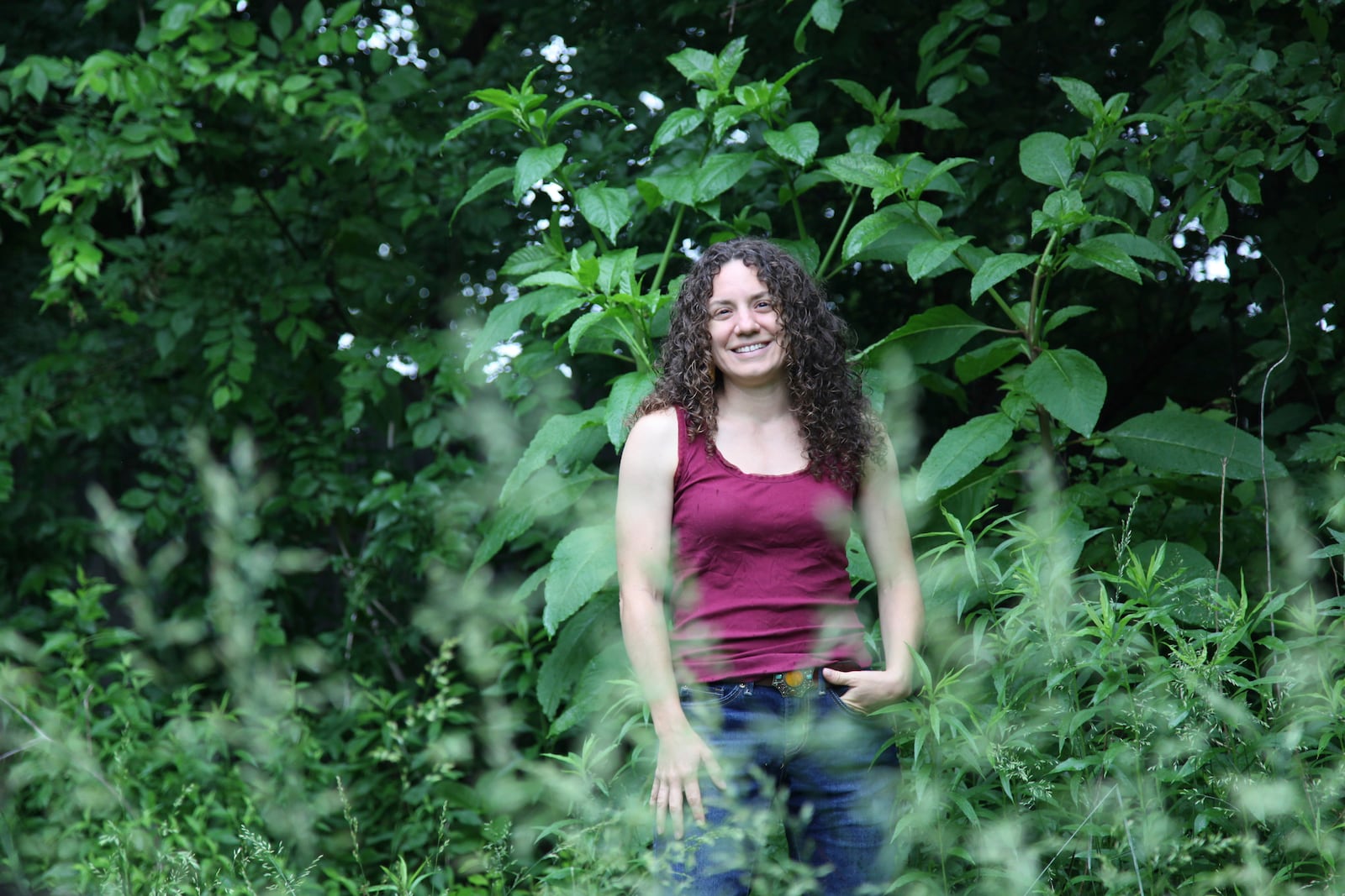 Amanda Beltranmini Healen stands among the plants in her backyard in Nashville, Tenn., Monday, May 19, 2025, where she participates in No Mow Months to improve water retention and encourage pollinators. (AP Photo/Kristin M. Hall)