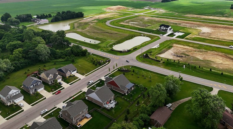 The Villages of Winding Creek, at bottom, and a new development underway across the 2000 block of East Lytle 5 Points Road, Ryan Homes at Copper Mill, are surrounded by farmland in Clearcreek Twp. NICK GRAHAM/STAFF