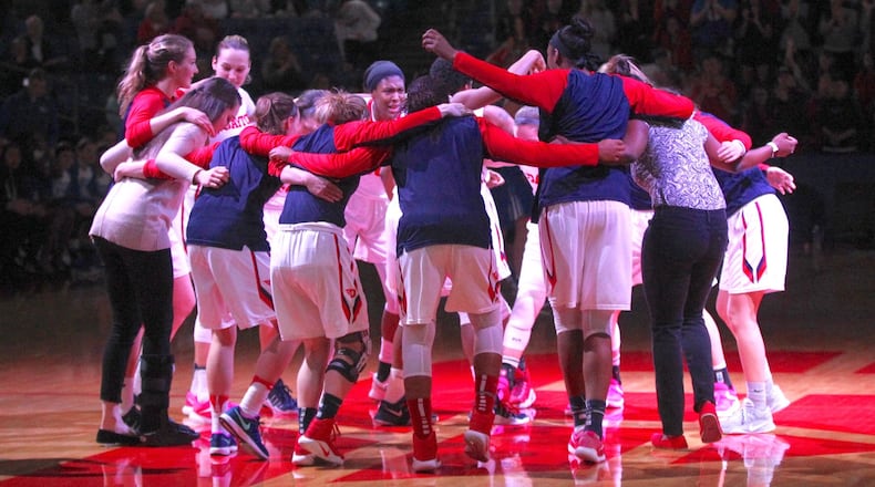Dayton players huddle before a game against Saint Louis in 2017 at UD Arena. David Jablonski/Staff