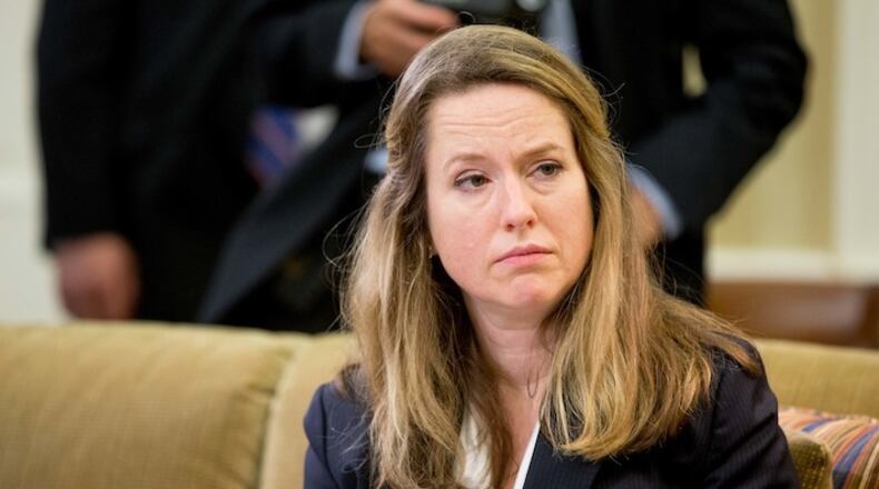 In this photo taken My 20, 2016, Deputy Homeland Security Adviser Amy Pope listens as President Barack Obama speaks in the Oval Office at the White House in Washington. The Obama administration will soon expand efforts to help Central American families and children legally immigrate to the United States amid another surge of migrants caught crossing the border illegally. Pope said Tuesday, July 26, 2016, that the administration will expand in-country refugee processing for families coming from Honduras, El Salvador and Guatemala and launch an effort to temporarily relocate some families to Costa Rica. (AP Photo/Andrew Harnik)