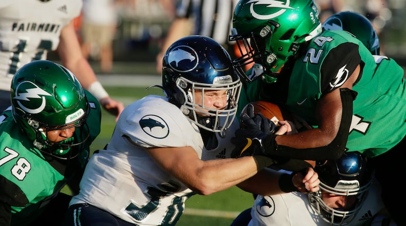 Northmont's Noah McClure scores a touchdown as he's hit by Fairmont's Drew Baker on Friday, Sept. 9, 2022, at Premier Health Stadium in Clayton. David Jablonski/Staff