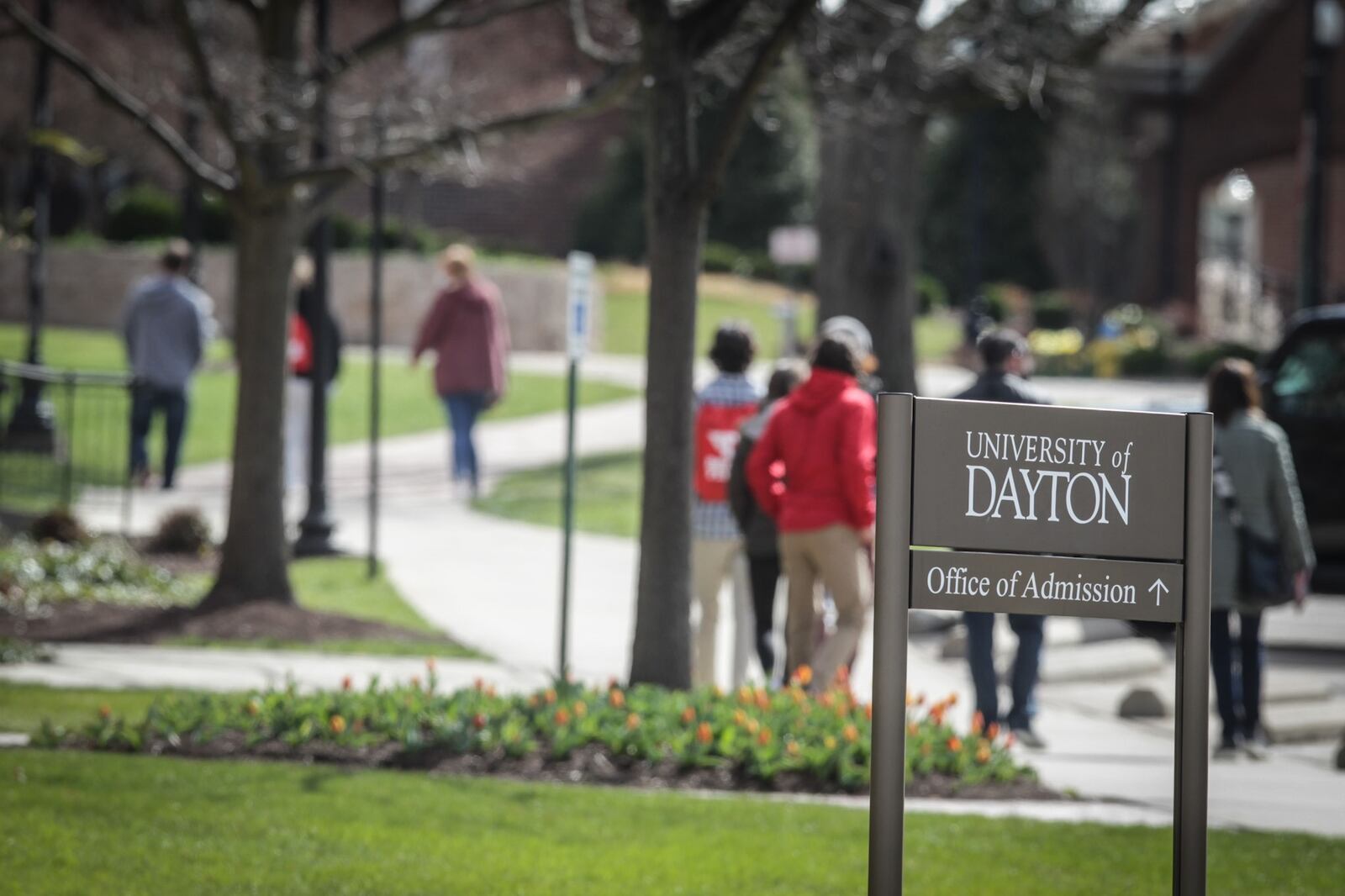 Students at the University of Dayton shuffle to class Thursday April 1,2021.The percentage of 2020 high school graduates enrolling immediately in college declined nationally by 6.8 percent this school year — an unprecedented drop, according to the National Student Clearinghouse — but local data was more mixed. JIM NOELKER/STAFF