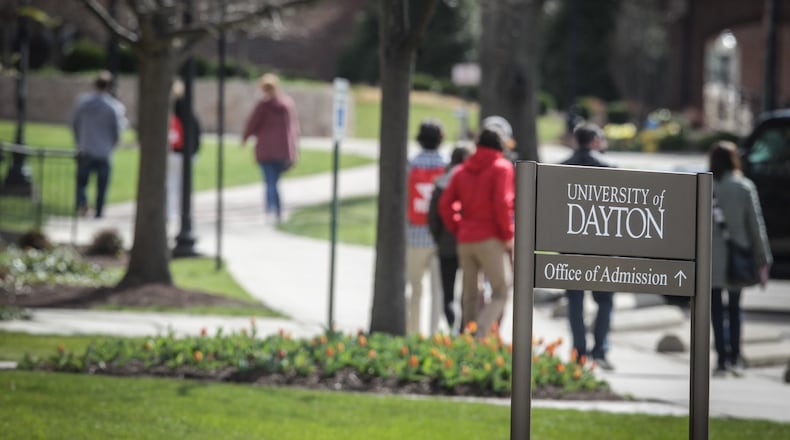 Students at the University of Dayton shuffle to class Thursday April 1,2021.The percentage of 2020 high school graduates enrolling immediately in college declined nationally by 6.8 percent this school year — an unprecedented drop, according to the National Student Clearinghouse — but local data was more mixed. JIM NOELKER/STAFF
