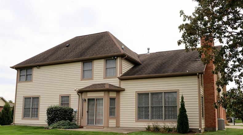 Sliding patio doors open to a concrete patio and open back yard.