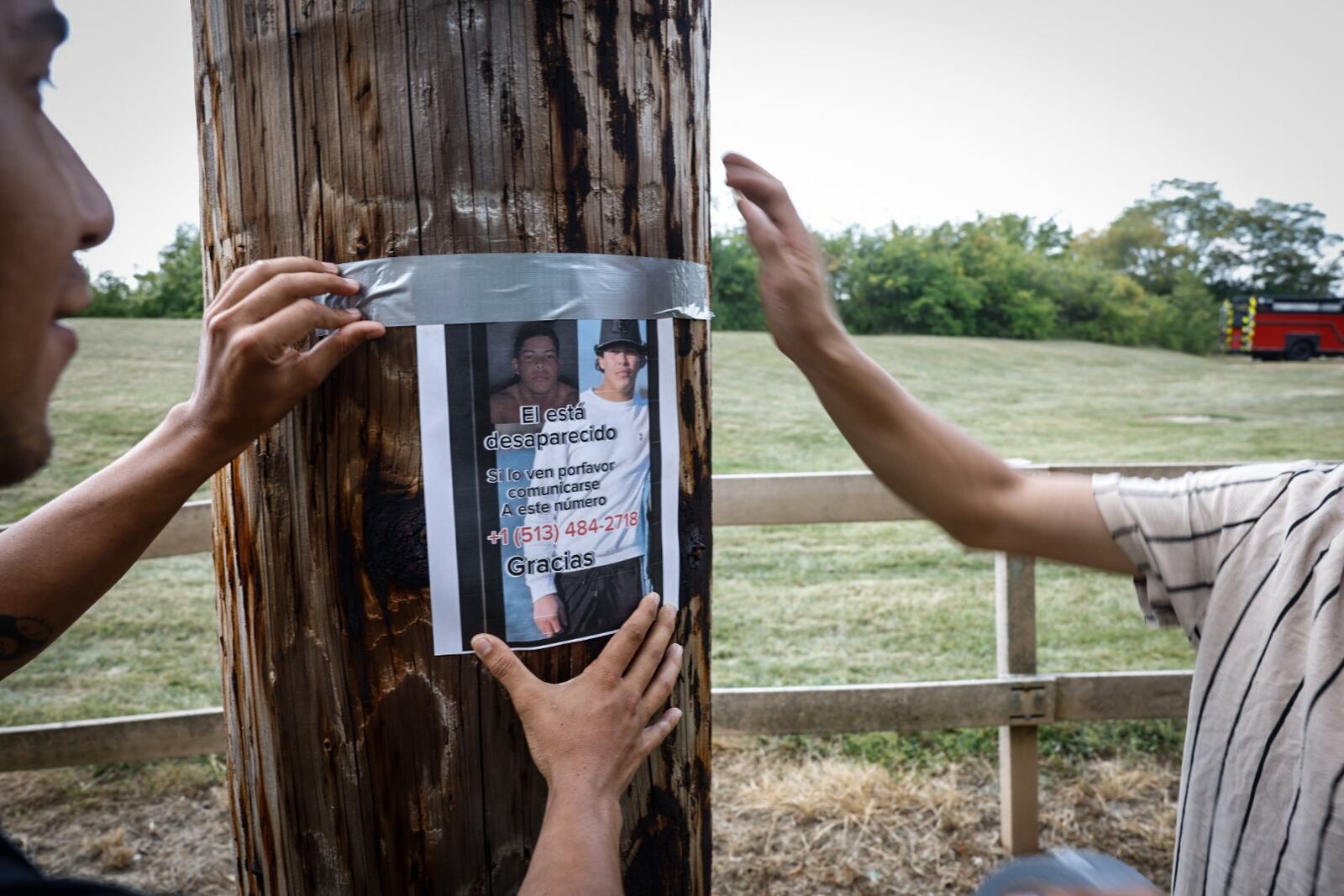 Friends of the missing young man at Madison Lakes put up posters of their missing friend on Olive Road Monday afternoon. Jim Noelker/Staff