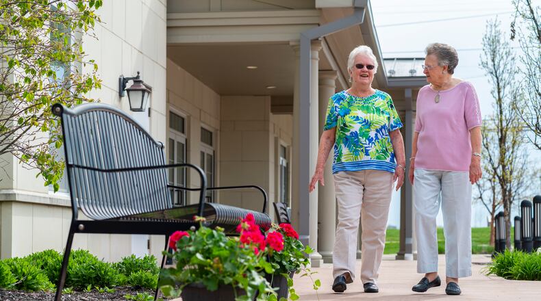 Fully vaccinated residents Grace Wilson and Nell Haeussler talk as they walk outside Otterbein Lebanon. Rules have been loosening and some activities have been restarting in long-term care, following widespread resident uptake of the vaccines. CONTRIBUTED