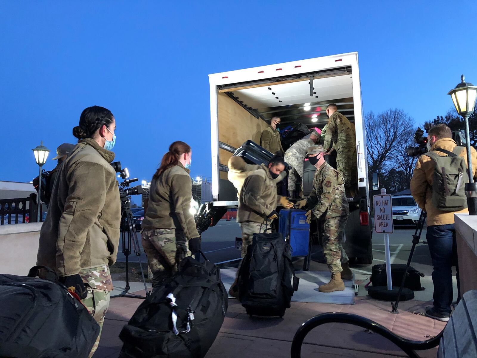 Airmen from Wright-Patterson load up a truck with their belongings. They are deploying to Detroit to help with a mass vaccination effort. STAFF/BONNIE MEIBERS