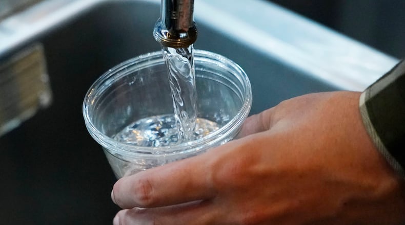FILE - A cup of water is drawn from a faucet at Johnny T's Bistro and Blues, a midtown Jackson, Miss., restaurant and entertainment venue on Sept. 1, 2022. The beleaguered water system in Mississippi's capital city disrupted daily life for 150,000 residents for several days, but Jackson's water is now safe to drink according to the Environmental Protection Agency on Monday, Oct. 31, 2022. (AP Photo/Rogelio V. Solis, File)
