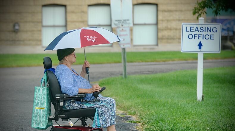 Carlene Strong is prepared for the rainy weather while heading to the store in Fairborn, Wednesday, June 30, 2021. MARSHALL GORBY\STAFF