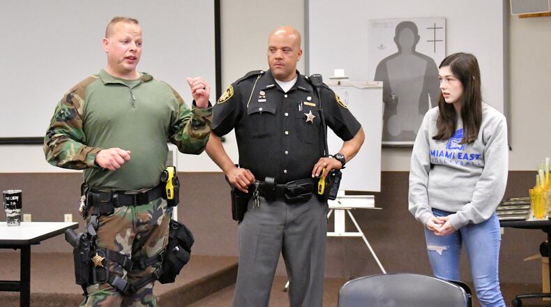 Miami County Sheriff’s Lt. Todd Tennant, left, and Deputy Warren Edmondson, center, talk with police academy students about standoffs with police and hostage negotiations. CONTRIBUTED