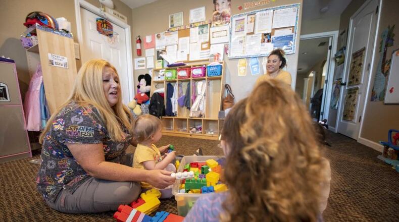 Kathy Vinsh, Tyndall Family Child Care provider, left, plays with children in her care in Panama City, Fla., March 21, 2022. (U.S. Air Force photo by Staff Sgt. Magen M. Reeves)