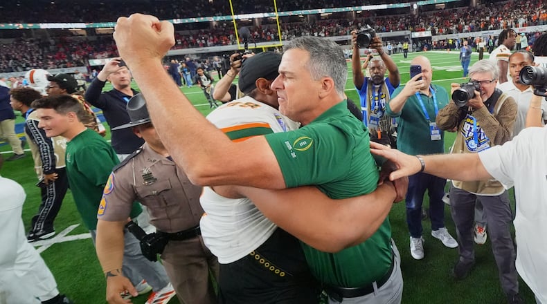 Miami head coach Mario Cristobal, right, hugs defensive lineman Ahmad Moten Sr. following the Cotton Bowl College Football Playoff quarterfinal game against Ohio State Wednesday, Dec. 31, 2025, in Arlington, Texas. (AP Photo/Julio Cortez)