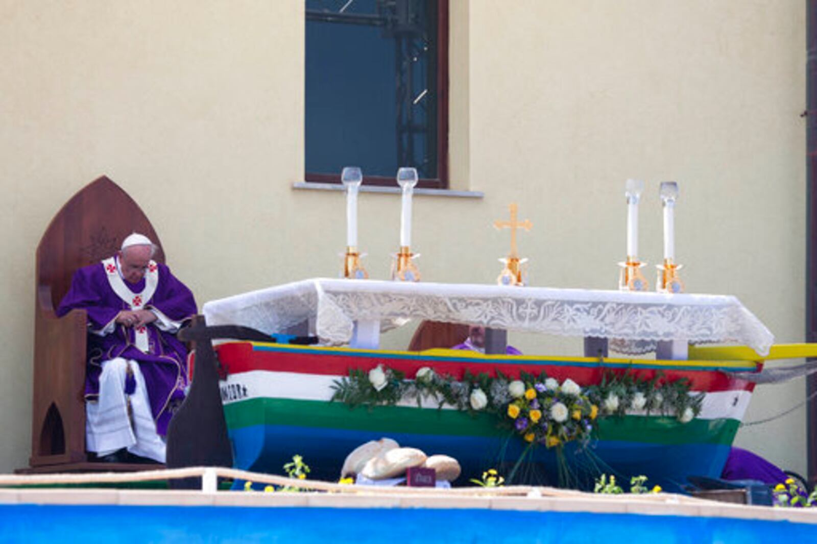FILE - Pope Francis celebrates a Mass in front of an altar made with recycled wood from a broken migrant boat, during his visit to the island of Lampedusa, southern Italy, Monday, July 8, 2013. (AP Photo/Alessandra Tarantino, file)