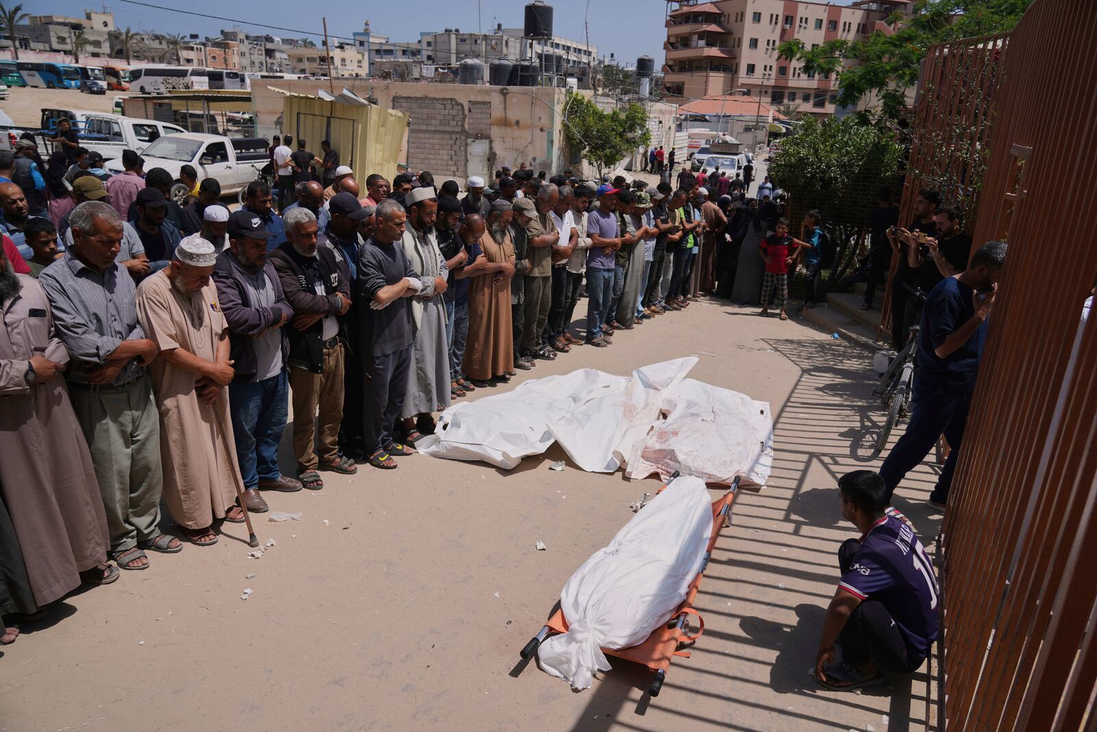 Palestinians pray during the funeral of a person who was killed along with a few others during an Israeli airstrike while heading to a Gaza aid hub, as they gather at the Nasser Hospital in Khan Younis, southern Gaza Strip, Sunday, June 1, 2025. (AP Photo/Abdel Kareem Hana)
