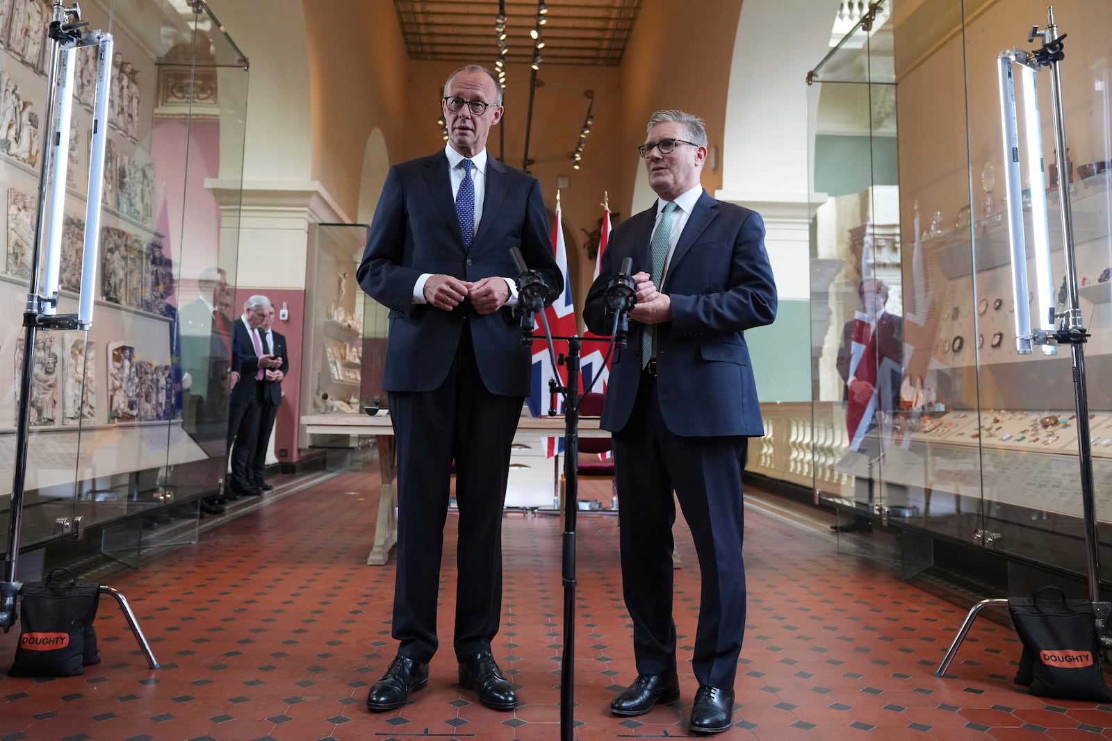 Britain's Prime Minister Keir Starmer, right, and German Chancellor Friedrich Merz, left, talk as they attend a signing ceremony of a wide-ranging bilateral cooperation treaty in London, Thursday, July 17, 2025.(AP Photo/Frank Augstein, Pool)