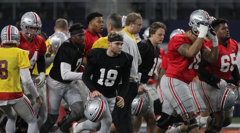 Ohio State players, including Tate Martell (18), break a huddle during practice at AT&T Stadium on Tuesday, Dec. 26, 2017, in Arlington, Texas. David Jablonski/Staff