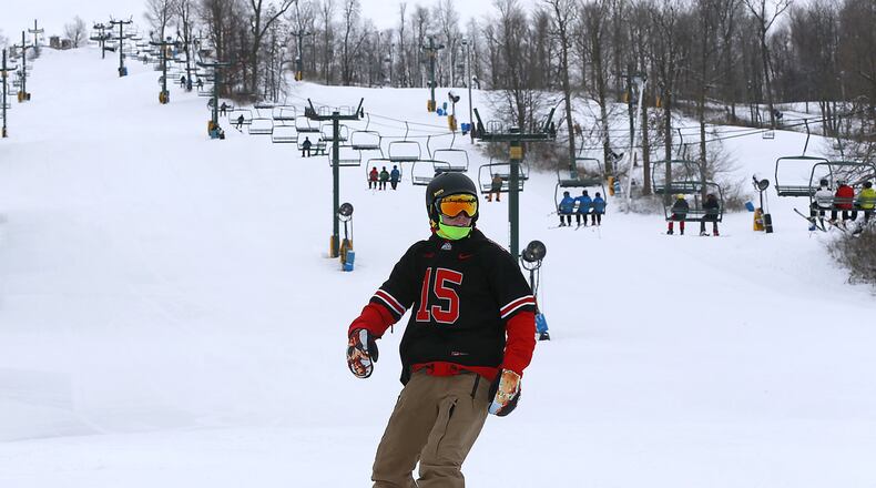 A snowboarder swishes down the slopes at Mad River Mountain earlier this month after it opened for season. The 14th annual Louie Vito Rail Jam for Charity will be held at Mad River on Saturday. Bill Lackey/Staff