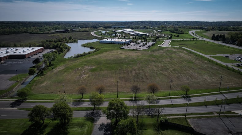 The Dayton Regional STEM School plans to buy more than 9 acres from the city of Kettering in Miami Valley Research Park to build a new elementary school. The existing STEM school building is at the left edge of the photo, with Woodman Drive at the bottom and the Research Park stretching away in the background. Jim Noelker/ Staff