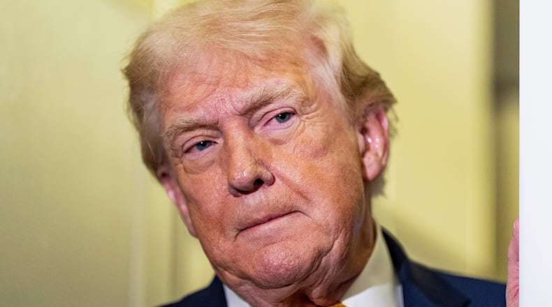 President Donald Trump listens as he was speaking with reporters while in flight on Air Force One, Sunday, Jan. 4, 2026, as returning to Joint Base Andrews, Md. (AP Photo/Alex Brandon)