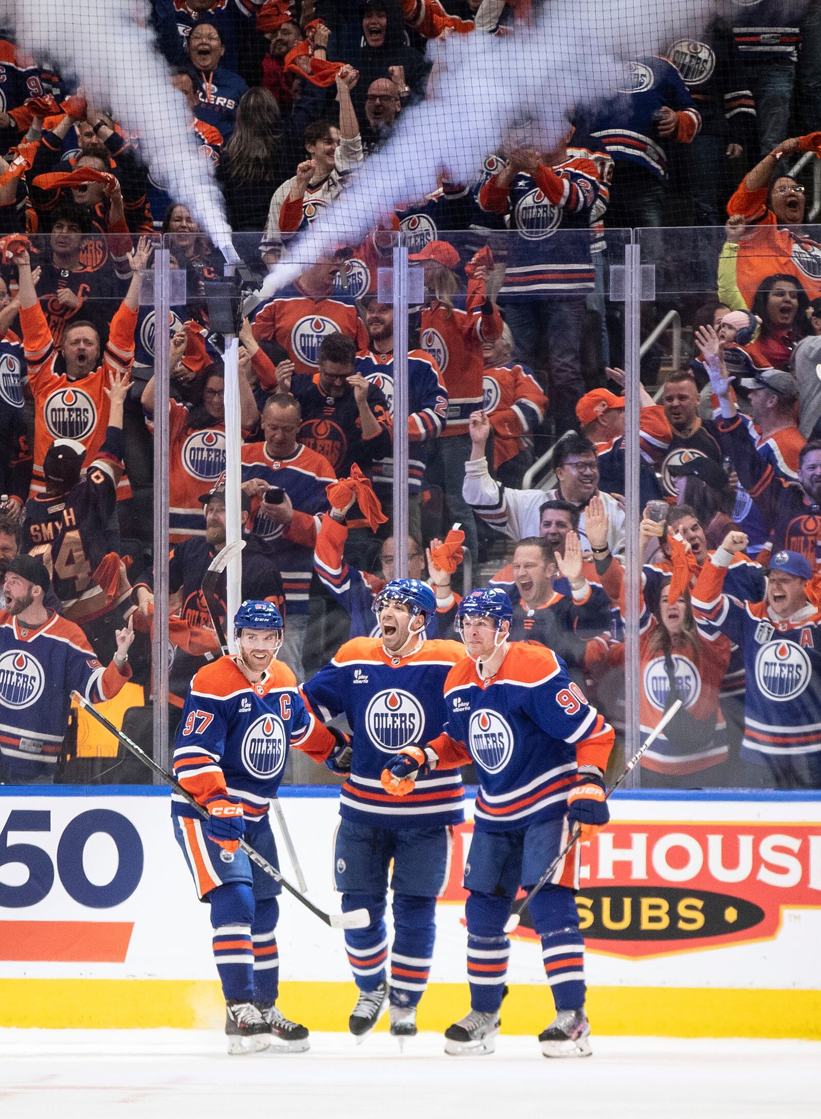 Edmonton Oilers' Connor McDavid (97), Evan Bouchard (2) and Corey Perry (90) celebrate a goal against the Los Angeles Kings during the third period of an NHL hockey playoff game in Edmonton, Alberta, Friday, April 25, 2025. (Jason Franson/The Canadian Press via AP)