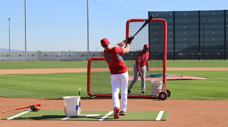 Former Reds shortstop Barry Larkin works with right fielder Jay Bruce at the team’s spring training complex on Wednesday, Feb. 24 in Goodyear, Ariz. Staff photo/Mike Hartsock